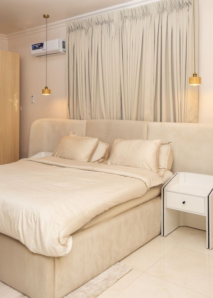 Stylish and cozy modern bedroom with neutral decor and soft lighting.